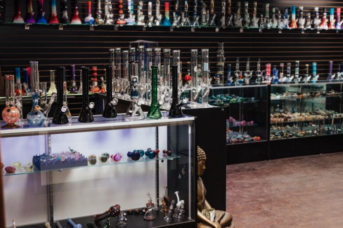 Glass display cases and shelves containing glass bongs at Parker, CO smoke shop