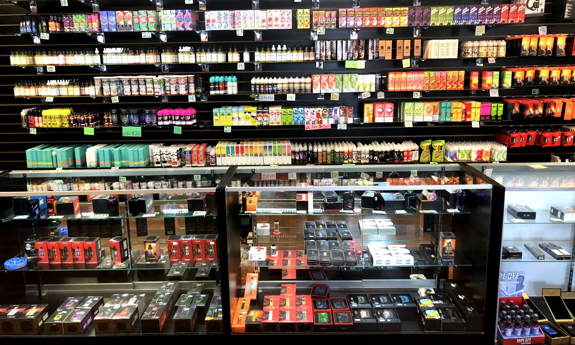 Glass shelves and wall display with e-juice and vaporizer selection in Parker, CO vape shop