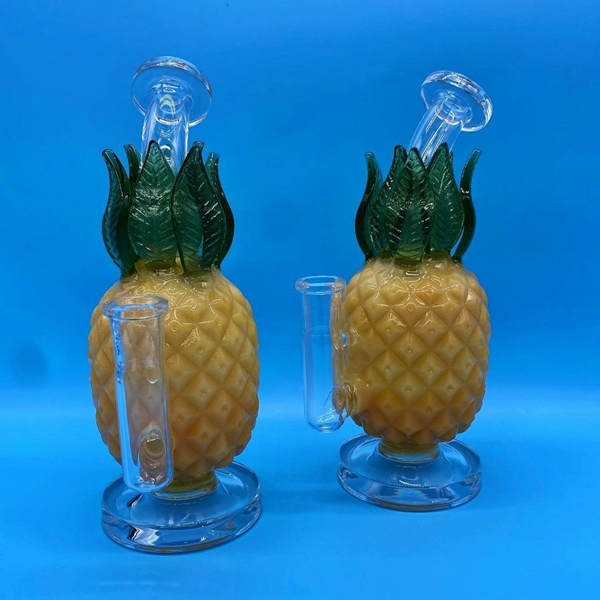 Two adjacent glass pineapple-shaped bongs